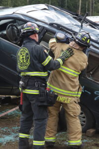 Volunteer firefighter training exercise with an active crew practicing hands-on skills shown in Action Training Systems firefighter 1 series